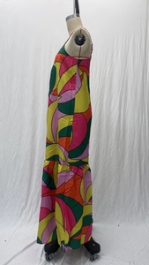 Detail of vibrant bohemian halter maxi dress featuring colorful patchwork and ruffled hem