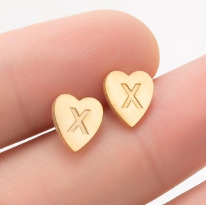 Polished gold stainless steel heart-shaped stud earring featuring an engraved letter X