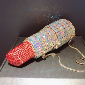 Detail of crystal lipstick clutch evening bag with red rhinestones and golden chain