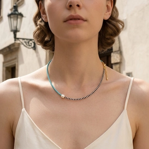 Detail of bohemian MGB glass bead necklace with asymmetrical blue and striped pattern