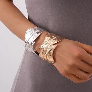 Polished metal leaf open bangles in gold and silver finish with textured fold details
