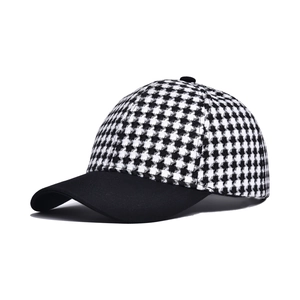 Classic houndstooth baseball cap with black curved brim and vintage crown design