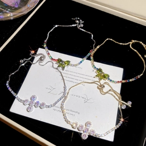 Close-up of adjustable butterfly and cross bracelets with sparkling cubic zirconia inlay
