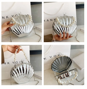 Detailed view of a stylish silver seashell clutch bag with pearl handle and chain