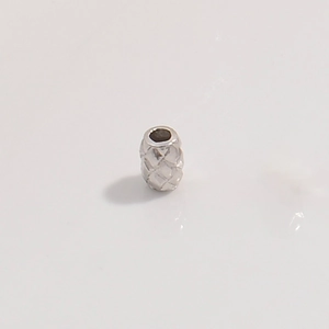 Detailed view of S925 silver quilted barrel beads with geometric textured finish