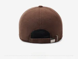 Close-up of brown wool baseball cap back showing metal adjustment buckle and mesh lining