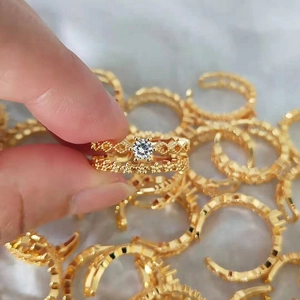 Detailed macro of gold-plated lace rings with cubic zirconia and adjustable open band