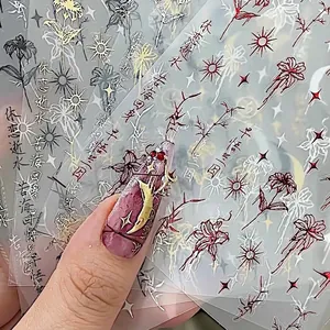 Retro gold foil nail art stickers featuring lily and heart patterns for manicures