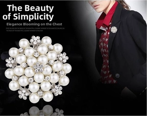 Macro detail showing white faux pearls and crystal rhinestones on a round floral brooch