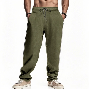 Detail of olive green corduroy sweatpants featuring white side stripes and elastic drawstring