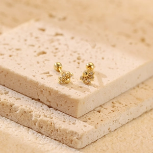 Detailed close-up of S925 silver gold-plated flower stud earrings with screw-back design