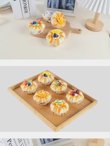 Detailed view of realistic PU artificial cakes with fruit toppings on a wooden tray