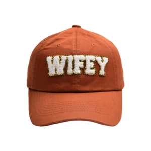 Close-up of WIFEY chenille letter embroidery with gold glitter on orange cotton baseball cap