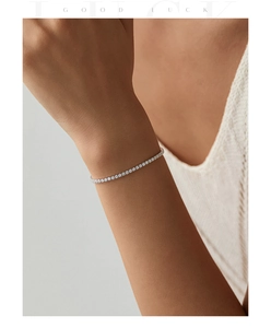 Close-up of S925 sterling silver tennis bracelet with cubic zirconia on female wrist