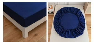 Detail of dark blue fitted sheet featuring elastic edges and smooth fabric texture