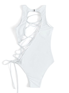 Flat lay of white one-piece swimsuit with open back and side lace-up strap details
