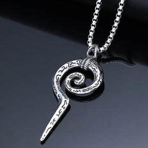 Macro shot of Viking rune serpent pendant on a black reflective background