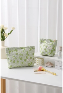Detail of green floral quilted cotton makeup bags in large and small sizes