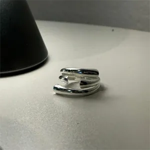 Macro shot of polished S925 sterling silver triple-layer ring with material hallmark