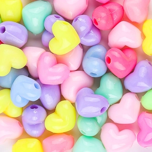 Macro view of assorted heart-shaped macaron plastic beads for DIY jewelry making
