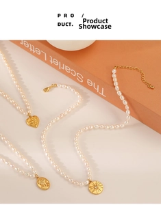 Detailed close-up of three pearl necklaces with gold heart, sunburst, and coin pendants