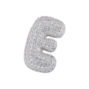 Macro detail of silver bubble letter E pendant encrusted with cubic zirconia stones