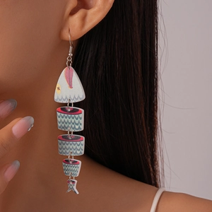 Macro detail of jointed fishbone earrings with red and blue wavy printed patterns