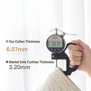 Thick quilted white cotton sofa cover showing 6.07mm thickness measurement with a gauge