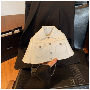 Detail of creative jacket shaped white crossbody bag with silver metal chain strap