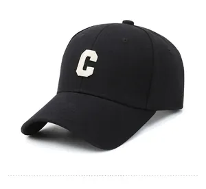 Detailed view of 3D white embroidered letter C on a premium black cotton baseball cap