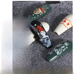 Detailed view of Christmas nail stickers with Santa Claus and snowflake motifs on nails