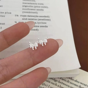 Detailed view of 925 silver butterfly earrings showing the delicate hollow design and size