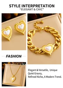 Detail of luxury heart pearl jewelry set with thick chain bracelet and gold earrings