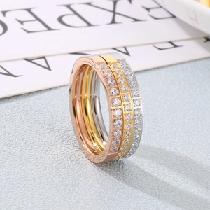 Three-tone stainless steel eternity rings set with pavé crystals in rose, gold, and silver