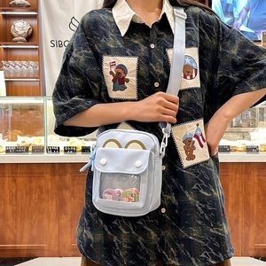 Light blue mini crossbody bag with clear window and bear embroidery shirt in a bakery