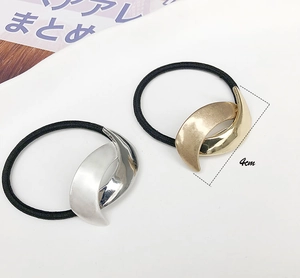 Detail showing minimalist 4cm gold and silver metallic ponytail cuff hair ties