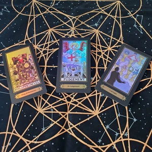 Detailed close-up of King of Pentacles and Judgement tarot cards with laser holographic finish