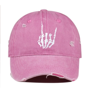 Pink washed cotton baseball cap with distressed details and white skeleton hand embroidery