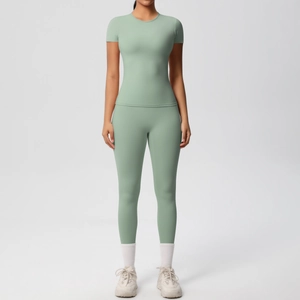 Close-up of mint green two-piece yoga set featuring a slim-fit short sleeve top and leggings