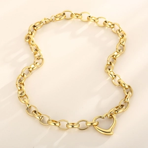 Macro view of gold chain necklace featuring a chunky link design and heart clasp pendant