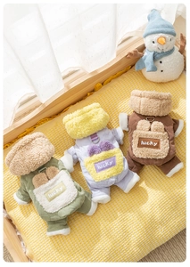 Detail of warm quilted pet coats in green, purple, and brown with soft fleece collars