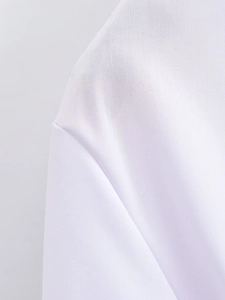 Detail of shoulder seam and bow sleeve on a white blouse with delicate plain weave fabric