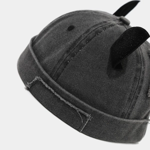Close-up of distressed denim miki hat featuring frayed edges and velvet fox ear details