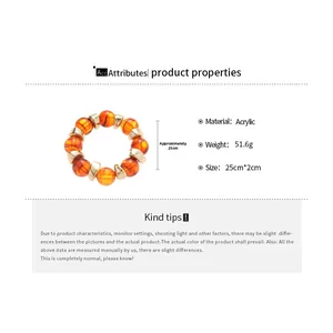 Acrylic bangle with orange tiger-print beads and gold metal spacers showing 25cm size detail