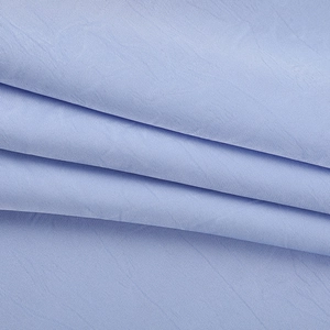 Detailed macro shot of light blue satin fabric texture and premium drape material
