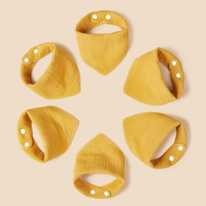 Detail of 6-pack yellow muslin cotton baby bibs with soft crinkle texture and snap buttons