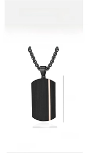 Detail view of black dog tag pendant with rose gold stripe and 40mm x 22mm dimensions