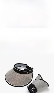 Detailed view of woven sun visor with 'G' logo and foldable breathable fabric