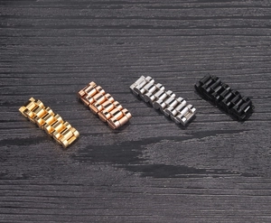 Detail of solid watch link rings in gold, silver, black, and rose gold finishes