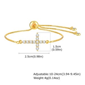 Detailed view of gold cross bracelet with cubic zirconia and dimension labels